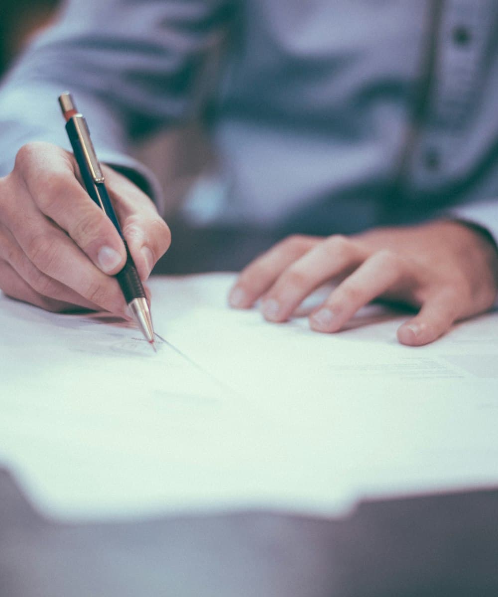 Consultant reviewing and signing financial documents